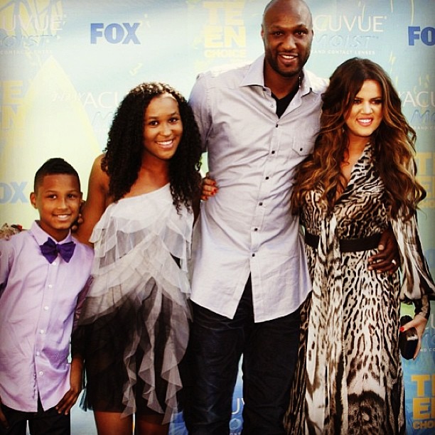 Destiny Odom in a black and white one piece with her stepmother in a black spotted white dress and her father and brother.